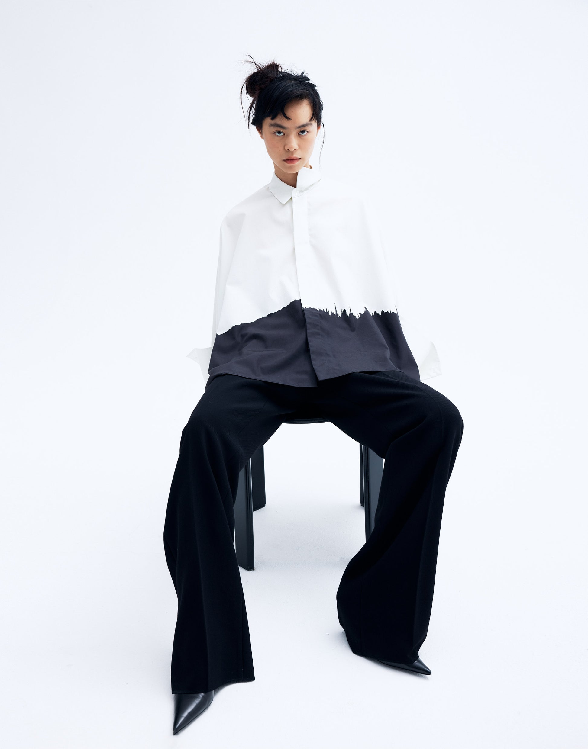 Model wearing a black and white printed cotton kimono shirt with wide sleeves and a relaxed silhouette, featuring an abstract brushstroke design.