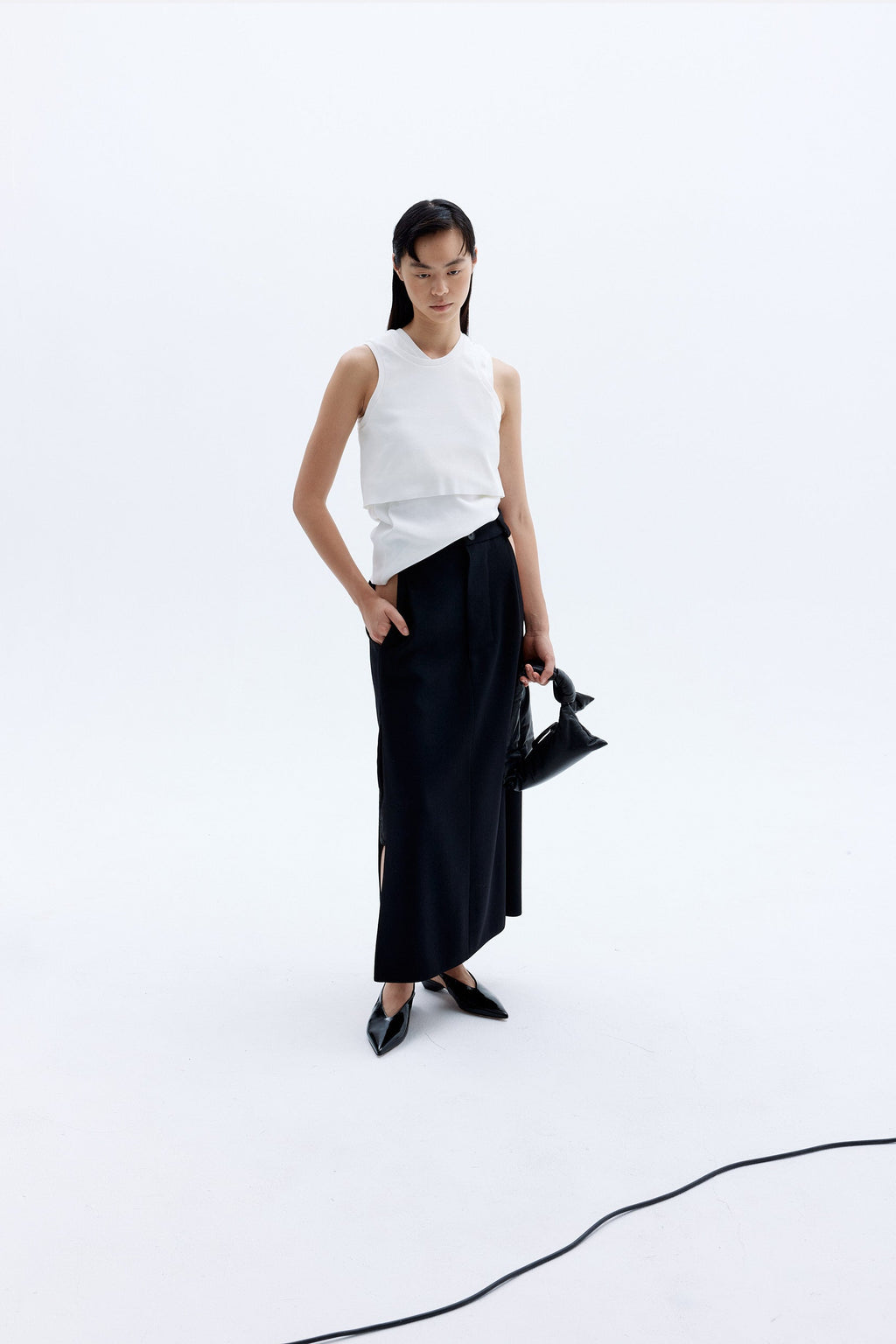 CARA carrying padded lambskin leather minibag with a knotted handle and zip closure