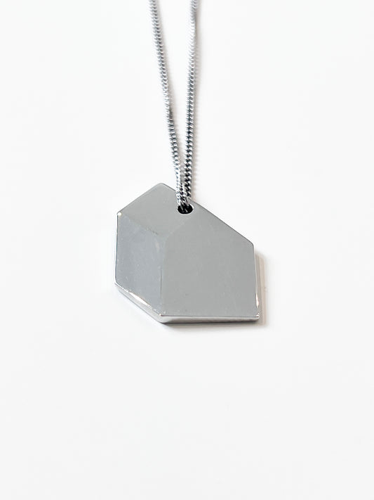 Close-up of polished 925 sterling silver necklace with balanced architectural proportions.