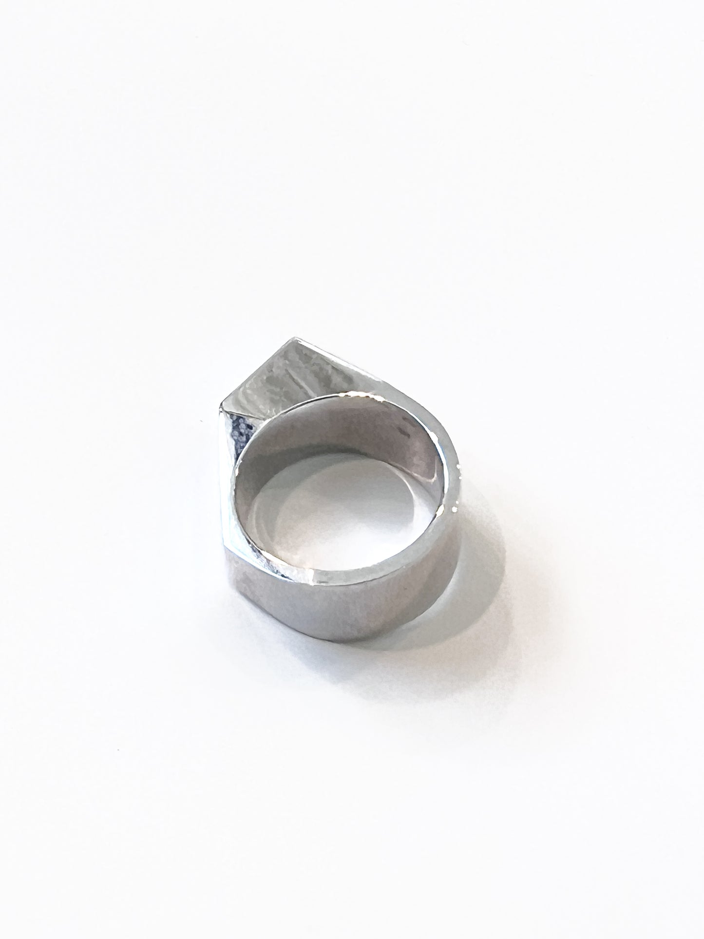 Sculptural ring crafted from solid 925 sterling silver with layered geometric silhouette.