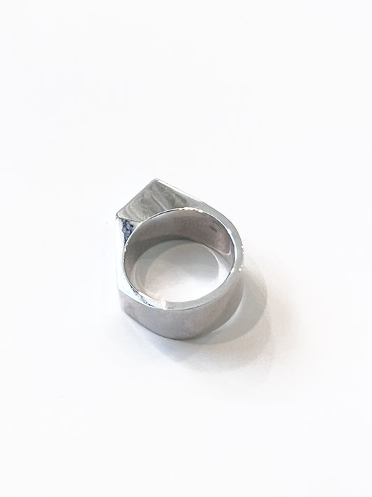 Sculptural ring crafted from solid 925 sterling silver with layered geometric silhouette.