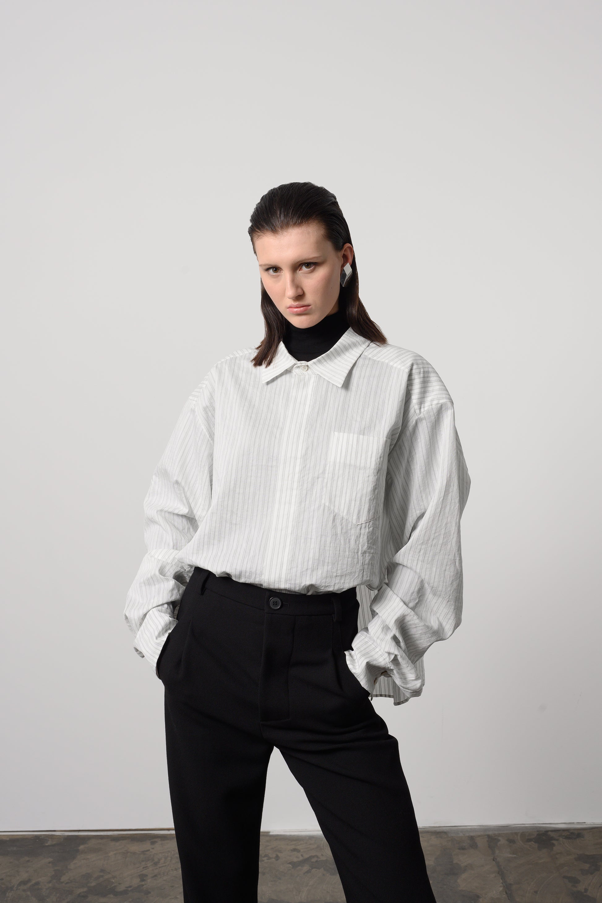 Model Zoe wears an elegant oversized cotton silk shirt with a classic collar and subtle striped pattern, ideal for both casual and formal wear.